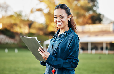 Image showing Coach, sports and portrait of woman with clipboard on field for training, planning and game strategy. Happy, writing and personal trainer outdoors for exercise, workout schedule and fitness routine