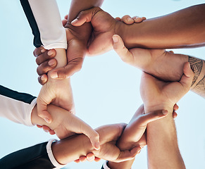 Image showing Hands, link or chain with people on team, collaboration and solidarity with support and connection low angle. Community, synergy and huddle with mission in group, meeting and communication of goals