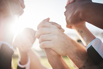 Image showing Holding hands in air, solidarity and support in team, group of people outdoor with sunshine, lens flare and winner. Celebration, mission and partnership with community, closeup of synergy and success