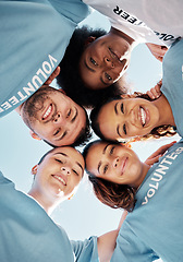 Image showing Huddle, faces and volunteer team from low angle together for charity donation as support, unity and teamwork. Diversity, group and people in collaboration at sustainability clean up on earth day