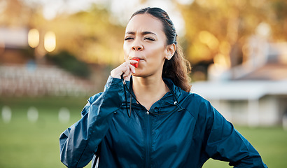 Image showing Coach, sports and woman blowing whistle on field for training, planning and challenge for games. Coaching, manager and personal trainer outdoor for exercise, workout schedule and fitness routine