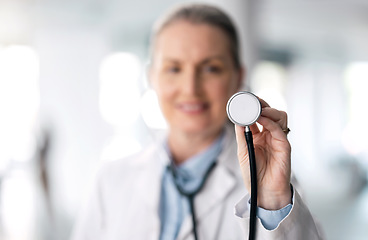 Image showing Senior woman, doctor and futuristic with stethoscope, smile and appointment with bokeh background. Mature person, medical professional or happy employee with hospital equipment, worker and healthcare