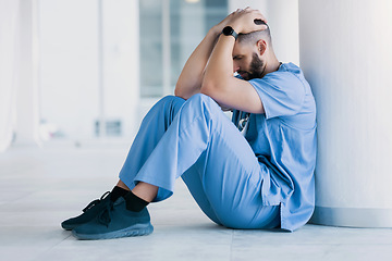 Image showing Doctor, stress and sad on floor for hospital mistake, healthcare fail or bad news of clinic death. Mental health of medical worker, tired man or nurse with headache, depression and anxiety or fatigue