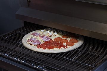Image showing Preparing pizza in oven