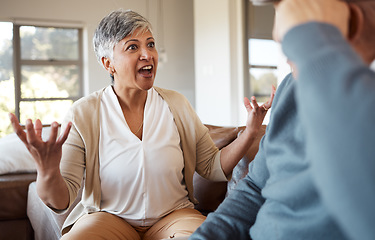 Image showing Divorce, fight and senior couple on a sofa angry, shouting and frustrated in their home together. Marriage, crisis and elderly people in a living room argue, stress and anxiety for debt, risk or liar