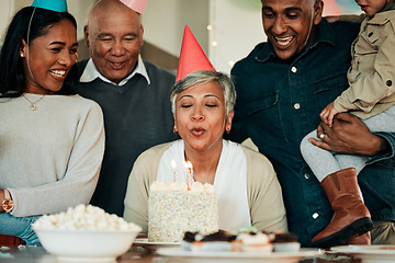 Image showing Happy birthday, candles or grandma in home for a family celebration, bond or growth together. Blow, senior lady or excited grandparents with cake, support or child at a fun party or special event