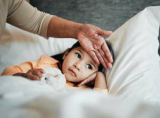 Image showing Girl kid, check for fever and sick in bed with hand on head, health and wellness, parent monitor temperature at home. Headache, illness and young child with the flu, medical help and support of mom