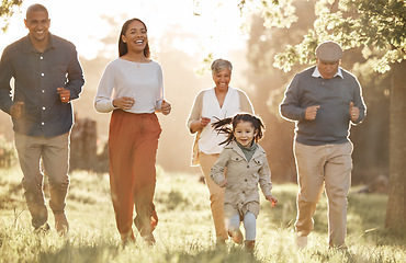 Image showing Park, running and child with parents or grandparents on grass field for freedom, adventure or playing in summer. Family, men or women with fun or love in forest with sunshine for care or happiness