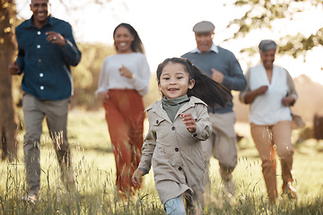 Image showing Park, running and girl with parents or grandparents on grass field for freedom, adventure or playing in summer. Family, men or women with fun or love in forest with sunshine for care or happiness