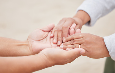 Image showing Hand holding, couple and marriage on beach, ring and love in commitment ceremony, anniversary or celebration. Wedding, man or woman on holiday, bonding together or closeup for support, care or peace