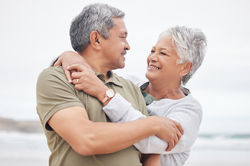 Image showing Senior couple, love and hug at beach for holiday, vacation or freedom to travel in retirement together. Happy man, elderly woman and embrace at ocean for trust, loyalty or relax with marriage partner