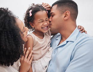 Image showing Family, beach and mother with father, girl and vacation with sunshine, bonding and weekend break. Parents, mama and dad with embrace, kid or child outdoor with happiness, seaside holiday and cheerful