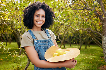 Image showing Woman in orchard, nature and agriculture with lemon in portrait, healthy food and nutrition with citrus farm outdoor. Farmer, picking fruit and smile with harvest, sustainability and organic product