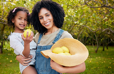 Image showing Woman with child, lemon orchard and nature, agriculture with healthy food and nutrition, portrait on citrus farm outdoor. Farmer, mother and daughter time picking fruit and smile, harvest and bonding