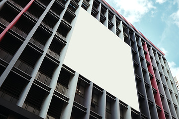 Image showing Office building, wall and empty billboard in city with space for advertising, marketing or promotion in urban cbd. Blank, poster or mockup for announcement banner with information, branding or promo