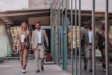 Image showing Modern business couple after a long day's work, walking together towards the comfort of their home, embodying the perfect blend of professional success and personal contentment.