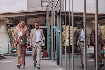 Image showing Modern business couple after a long day's work, walking together towards the comfort of their home, embodying the perfect blend of professional success and personal contentment.