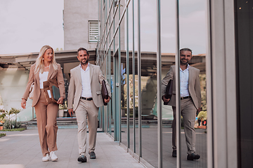 Image showing Modern business couple after a long day's work, walking together towards the comfort of their home, embodying the perfect blend of professional success and personal contentment.