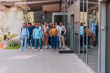 Image showing A diverse group of businessmen and colleagues walking together by their workplace, showcasing collaboration and teamwork in the company.