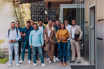 Image showing A diverse group of businessmen and colleagues walking together by their workplace, showcasing collaboration and teamwork in the company.