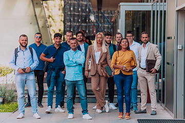 Image showing A diverse group of businessmen and colleagues walking together by their workplace, showcasing collaboration and teamwork in the company.