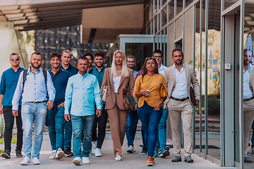 Image showing A diverse group of businessmen and colleagues walking together by their workplace, showcasing collaboration and teamwork in the company.