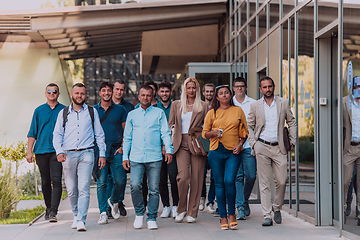 Image showing A diverse group of businessmen and colleagues walking together by their workplace, showcasing collaboration and teamwork in the company.