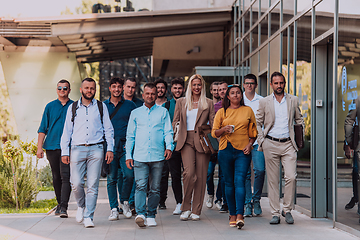 Image showing A diverse group of businessmen and colleagues walking together by their workplace, showcasing collaboration and teamwork in the company.