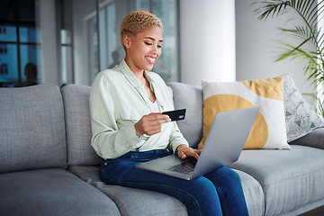 Image showing Woman, laptop and credit card for home online shopping, fintech payment and e commerce on her sofa. African person on computer for internet banking, website subscription or application for loan