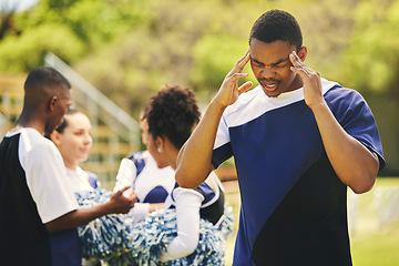 Image showing Cheerleader, fitness injury and man headache from sport, training and cheer exercise on a grass field. Stress, accident and burnout outdoor with migraine pain and workout challenge for wellness