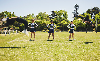 Image showing Cheerleader team, practise or sports field for exercise, routine and uniform for fitness, dancers or support. Students, motion or in air for dance, wellness and train with smile, energy and formation