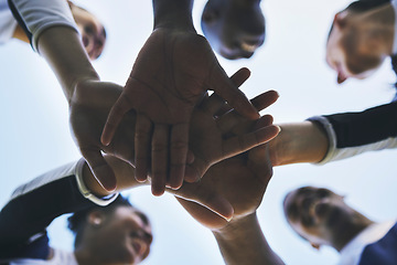 Image showing Cheerleader, hands or people in huddle for motivation with support, hope or goal in game on field. Teamwork, low angle or group of sports athletes cheerleaders with pride, plan or solidarity together