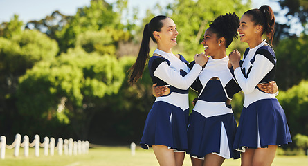 Image showing Group, hug or happy cheerleader with women outdoor in training or sports event together. Teamwork, smile or proud girl by an excited cheer squad on field for support, winning celebration or fitness