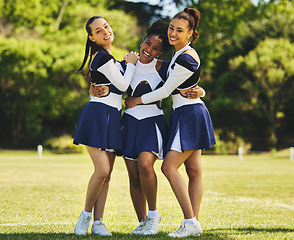 Image showing Teamwork, hug or portrait of cheerleader with women outdoor in training or sports event together. Diversity, smile or girl by a happy cheer squad group on field for support, solidarity or fitness
