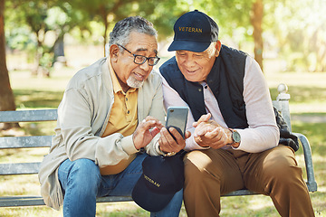 Image showing Elderly men, friends and phone in park, reading and army memory with thinking, relax and sunshine. Senior military veteran, smartphone social media and talk on bench, nostalgia and remember service