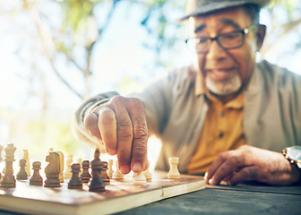 Image showing Old man in park, hand with chess game and strategy, competition or challenge, retirement and moving piece. Closeup, planning and contest outdoor, concentration on boardgame and recreation in nature