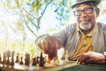 Image showing Elderly man in park, hand and chess game strategy, competition or challenge, retirement and moving piece. Closeup, planning and contest outdoor, concentration on boardgame and excited in nature