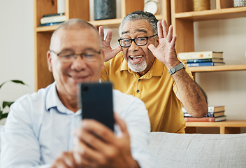 Image showing Funny, selfie and men in a house as friends in retirement for relax, comedy and internet. Happy, together and senior or elderly people with a phone for a photo or video call with a comic gesture