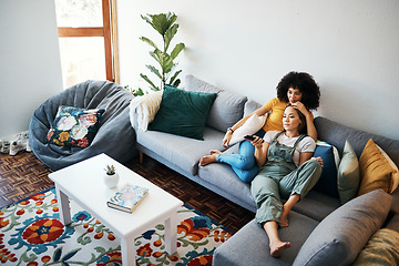 Image showing Lesbian couple, relax and watching tv on couch, hug and comfort in home or living room, bonding and chilling. Happy cozy people, streaming a series or movie with remote for quality time, love and joy