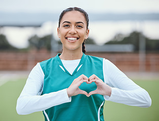 Image showing Portrait, heart hands or happy with woman on sports field for fitness, exercise or workout for wellness. Love sign, hand gesture or healthy athlete in training game for hockey or emoji with smile