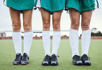 Image showing Legs, feet and a woman hockey team outdoor on a field for a game or competition together in summer. Fitness, exercise or sports with people on a pitch of a grass for training or teamwork on match day