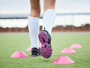 Image showing Cone, legs or athlete running in sports training, workout and warm up exercise on a outdoor hockey turf. Footwear closeup, back or fast person on grass pitch playing in a game for fitness speed
