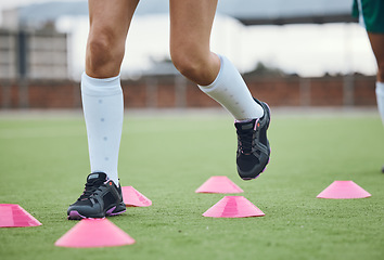 Image showing Cone, legs or athlete running in training, workout and warm up exercise on a outdoor hockey field or turf. Closeup, healthy or sports person on grass playing in a practice game for fitness speed