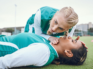 Image showing First aid, cpr and breathing with a hockey player on a field to save a player on her team after an accident. Fitness, emergency and heart attack with a woman helping her friend on a field of grass