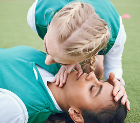 Image showing First aid, breathing and emergency with a hockey player on a field to save a player on her team after an accident. Fitness, cpr and heart attack with a woman helping her friend on a field of grass