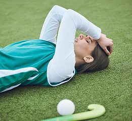 Image showing Hockey player, woman is tired in field with fitness and sport, challenge or loss with burnout outdoor. Exercise, wellness and fatigue with fail in competition, mistake and crisis on stadium turf