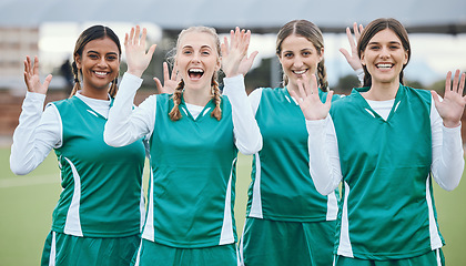 Image showing Sports, women and team with hands for hello or wave with happiness on field outdoor for teamwork, training or workout. Football, group and girls with diversity and hi in nature for game or exercise