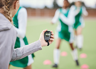 Image showing Coach, timer and team in training, field and sports in blurred background. Trainer, stopwatch and teaching for progress, fitness and performance by digital, athlete and exercise in diversity on clock