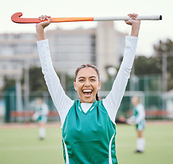 Image showing Hockey player in portrait, woman on turf with celebration and smile for fitness and sports win during game. Cheers, happiness and young athlete with stick, success and champion in competition