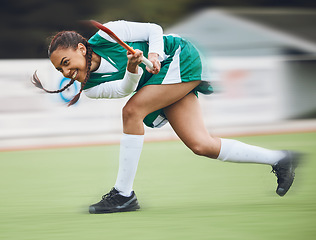 Image showing Hockey, sports or girl running in game, tournament or competition with ball, stick or action on turf. Blur, woman training or fast player in exercise, workout or motion on artificial grass for speed
